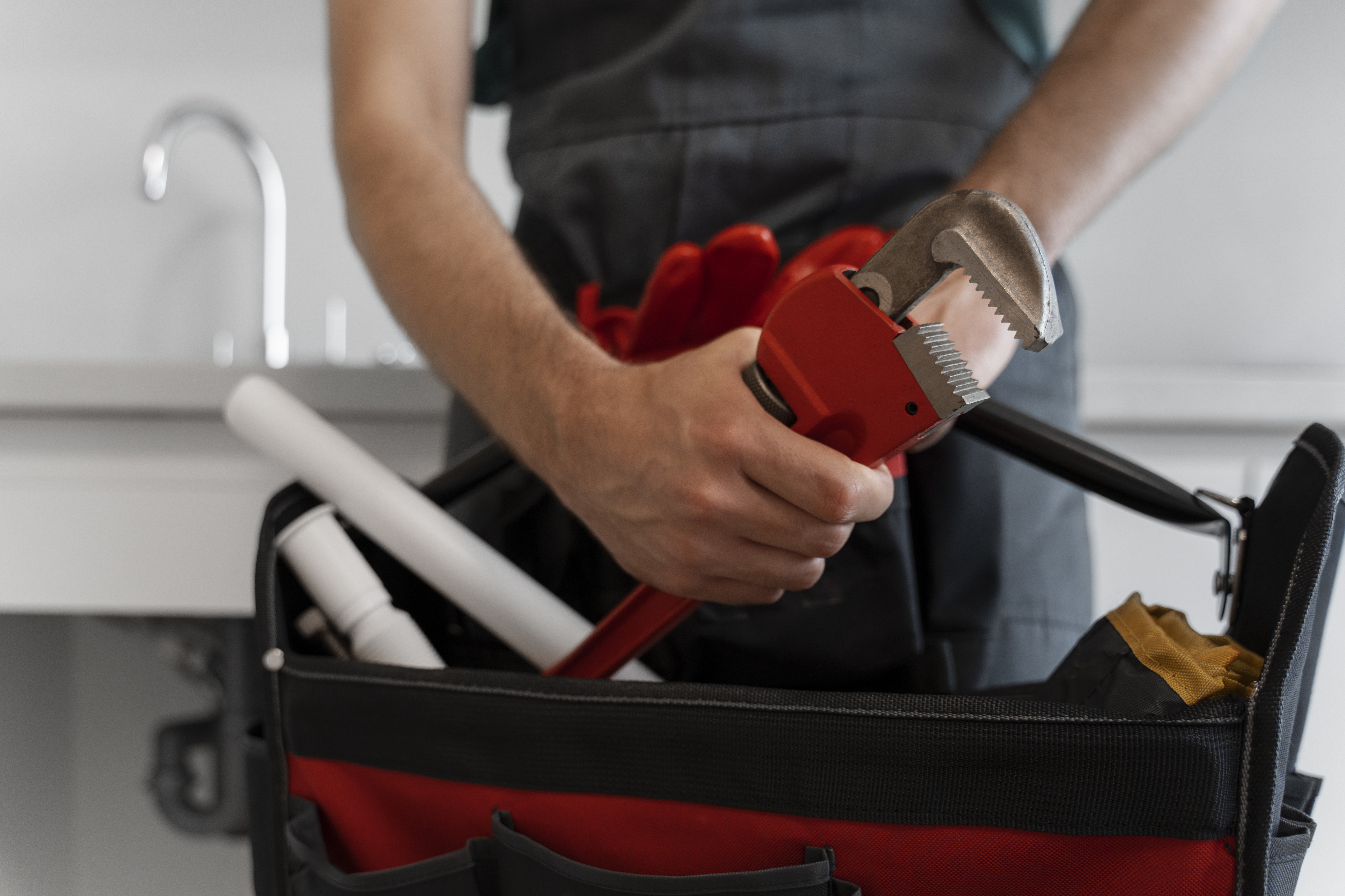 Professional plumber working in Macon GA home